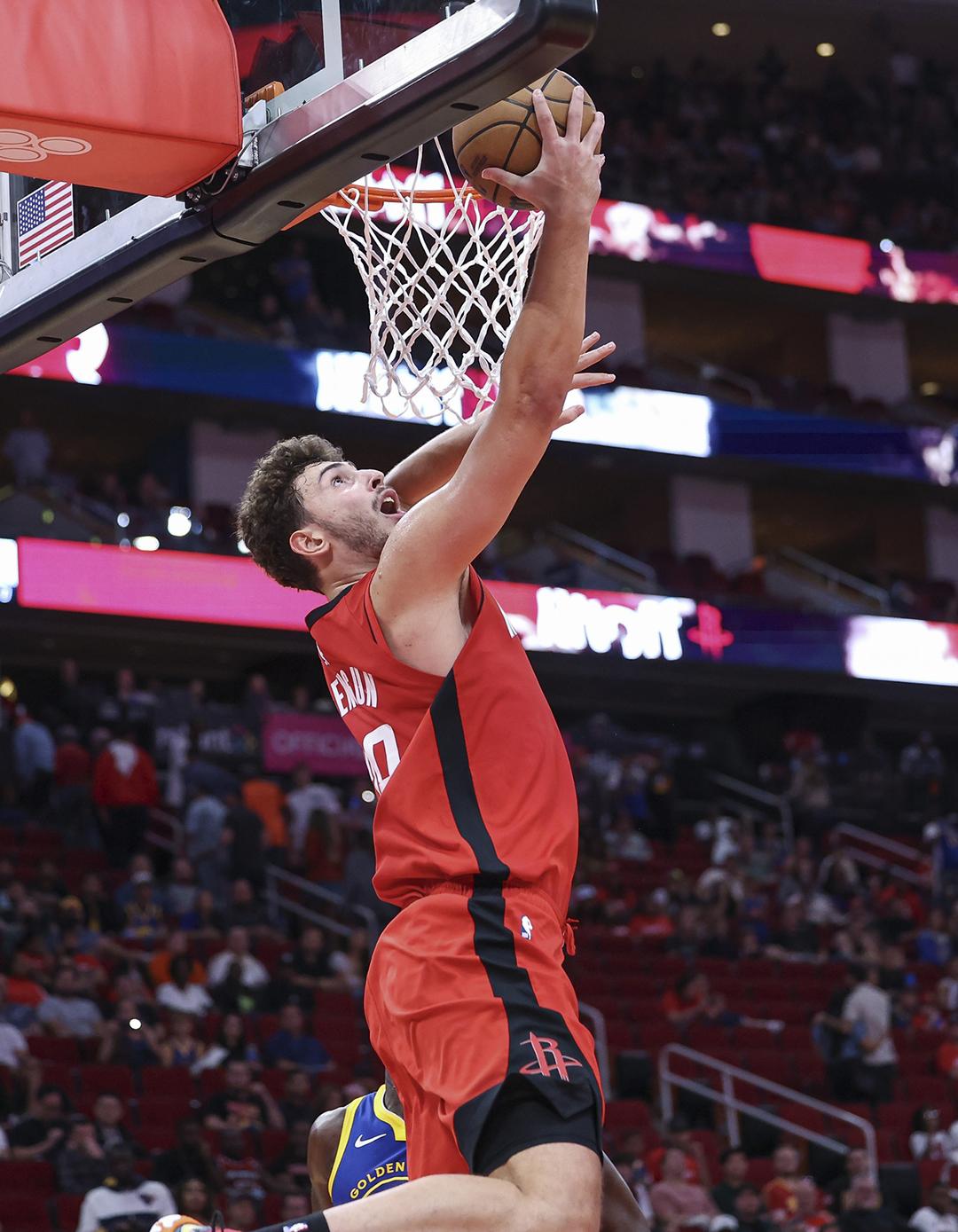 Houston Rockets center Alperen Sengun scores a basket 